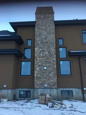 Luxury home with exterior stone chimney