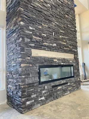 Stacked stone fireplace with linear insert