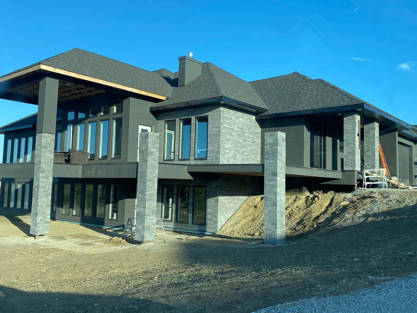 Custom stone patio and pillars by Olympus Masonry