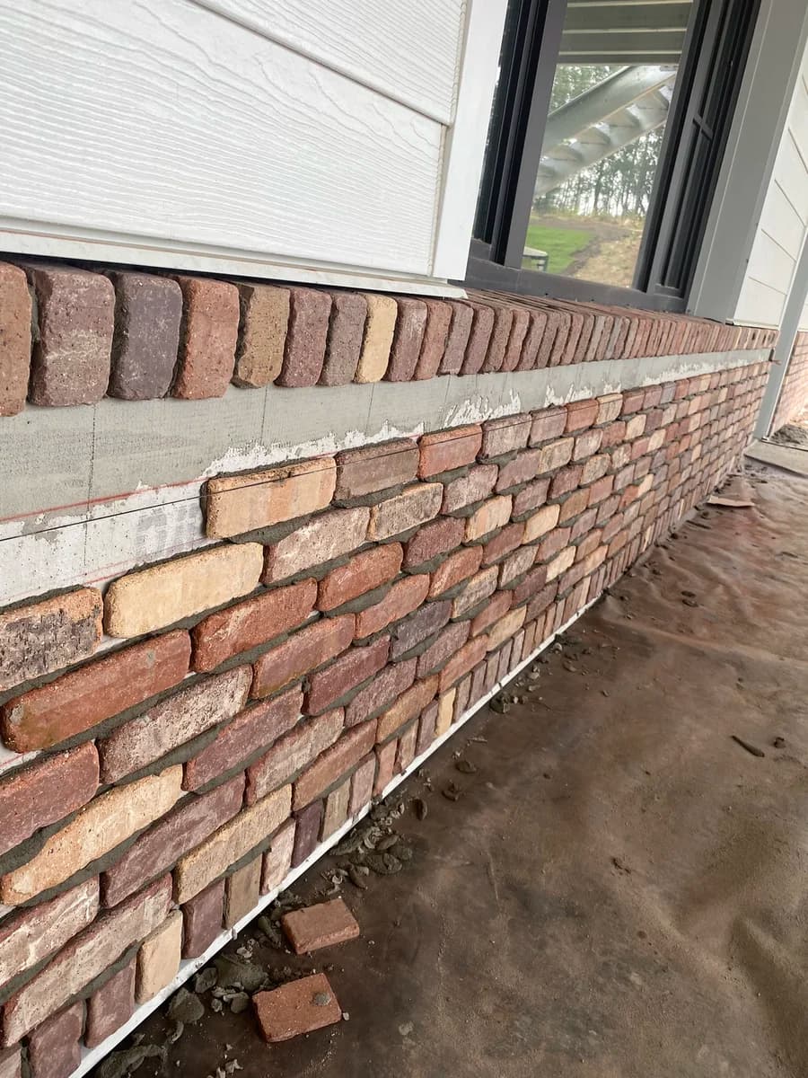 Brick retaining wall with decorative caps